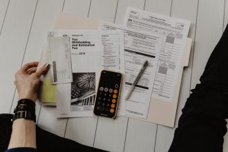 Founder reviewing financial paperwork with a pen and calculator