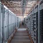 Data center aisle lined with metal server racks