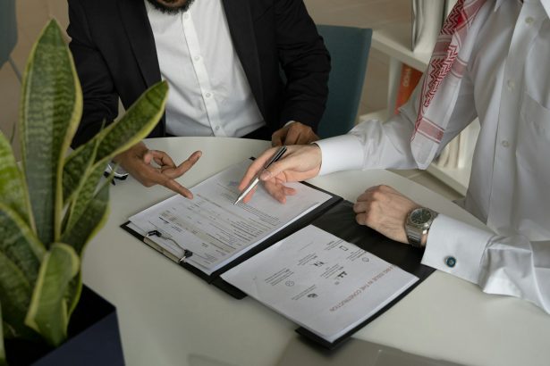 Two co-founders reviewing printed documents together at a table