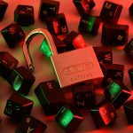 Open padlock among scattered keyboard keys under coloured light
