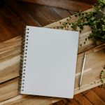 Notebook and pen on a wooden table in a quiet workspace