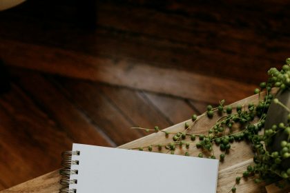 Notebook and pen on a wooden table in a quiet workspace
