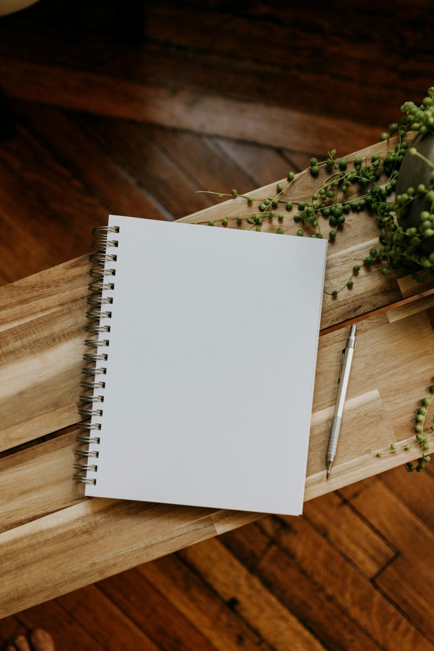 Notebook and pen on a wooden table in a quiet workspace