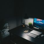 Uncluttered desk with a single monitor and keyboard