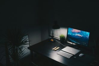 Uncluttered desk with a single monitor and keyboard