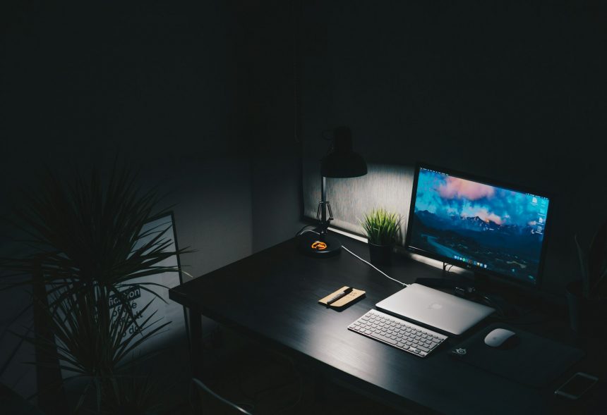 Uncluttered desk with a single monitor and keyboard