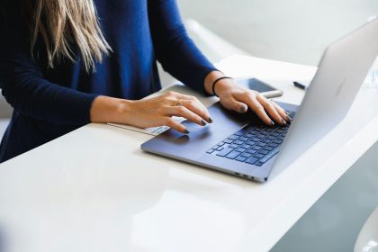 Knowledge worker reviewing output on a laptop at a bright desk