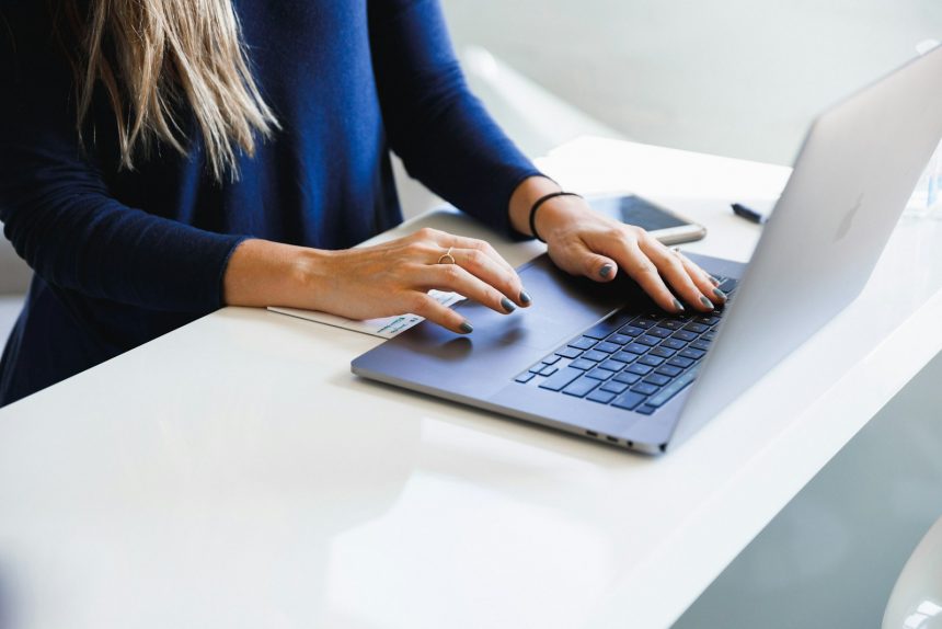 Knowledge worker reviewing output on a laptop at a bright desk