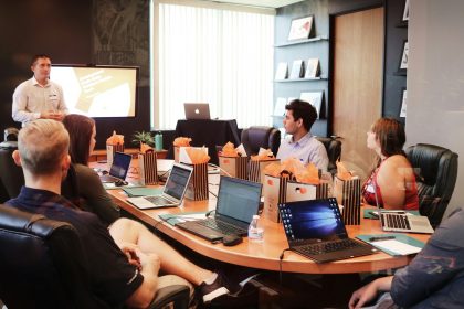 Manager presenting a budget proposal to colleagues around a meeting table