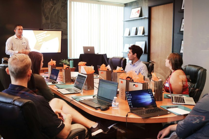 Manager presenting a budget proposal to colleagues around a meeting table