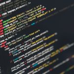 Developer monitor displaying lines of application source code