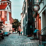 Quiet cobblestone street with a clock tower in a small town