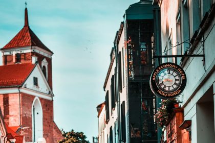 Quiet cobblestone street with a clock tower in a small town