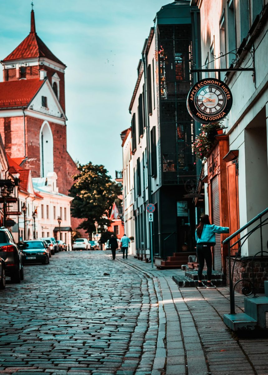 Quiet cobblestone street with a clock tower in a small town