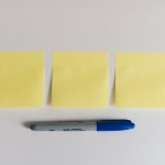 Yellow sticky notes and a marker used for idea validation