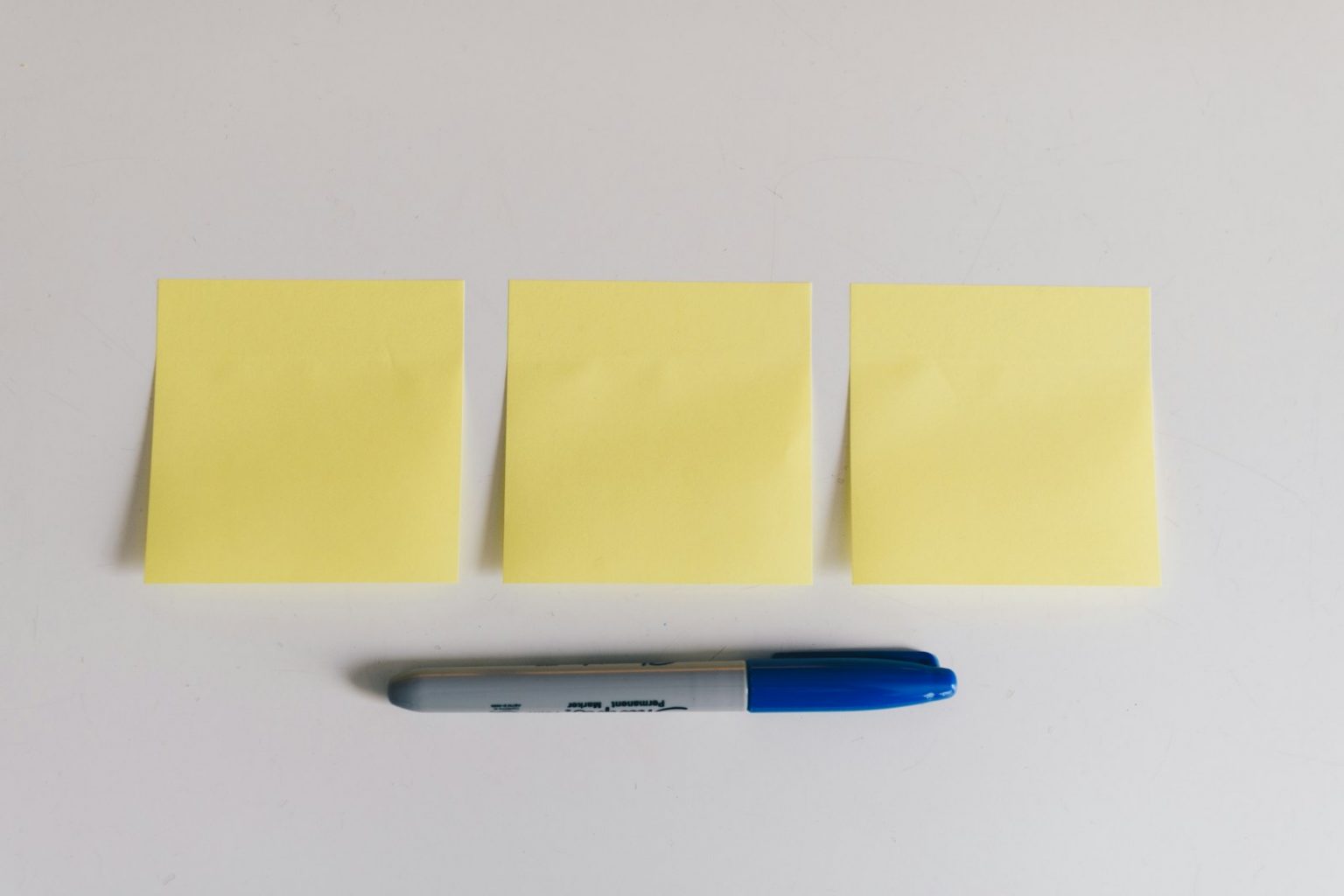Yellow sticky notes and a marker used for idea validation