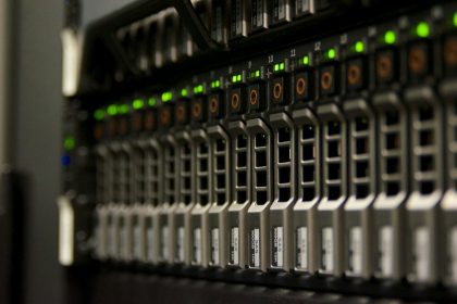Server rack with blinking green status lights in a small equipment room