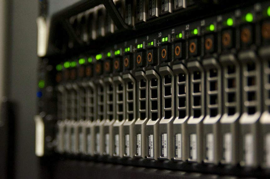Server rack with blinking green status lights in a small equipment room