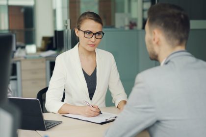 Two people conducting a job interview across an office desk