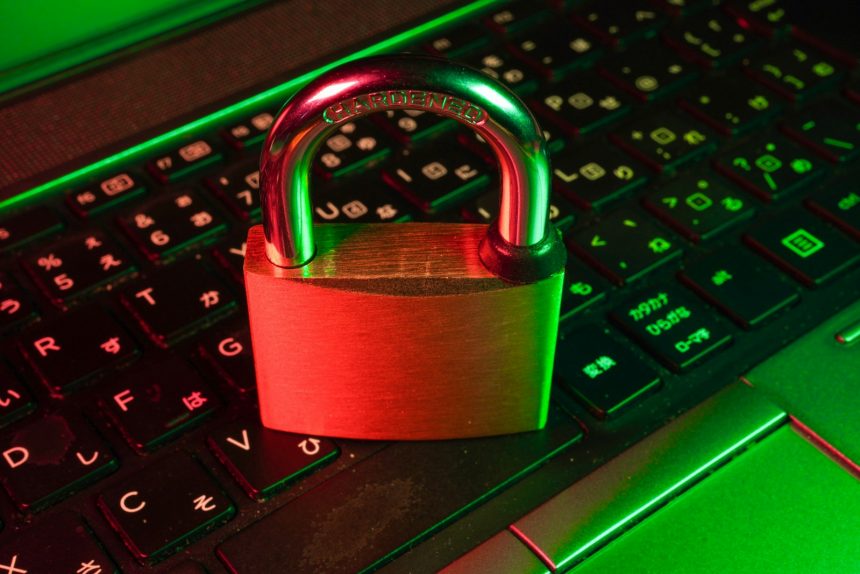 Red padlock resting on a black computer keyboard